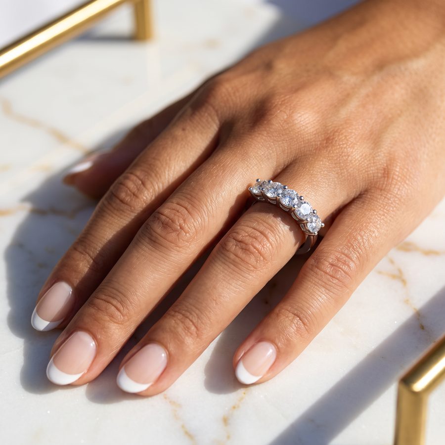 Diamond eternity ring on a hand over a marble surface, AI lifestyle render